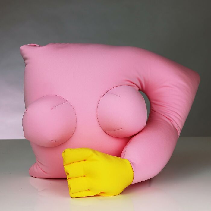 Playful pink pillow with a yellow hand design, perfect hilarious Valentine's Day gift for a fun-loving partner.