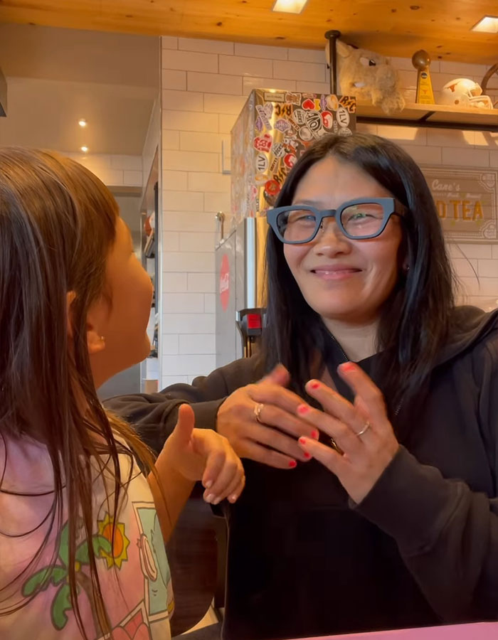 10YO deaf girl reacting with joy as she experiences speech visualization for the first time, an emotional moment.