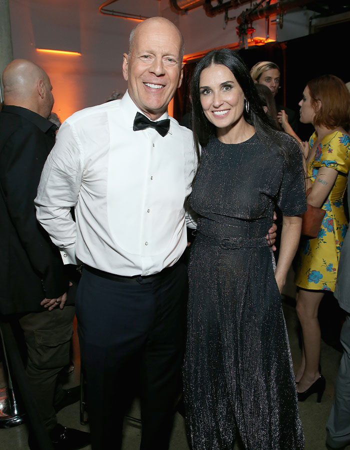 Demi Moore and Bruce Willis smiling together at an event, highlighting a heartfelt moment amid his dementia battle.