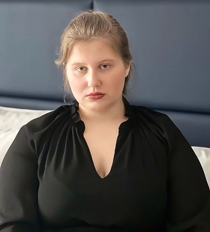 A woman in a black top sitting on a bed, related to the Polish woman claiming to be Madeleine McCann case.