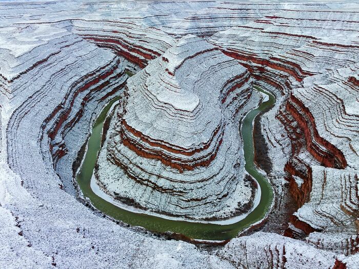 Nature textures: Aerial view of a snowy canyon with a winding river.