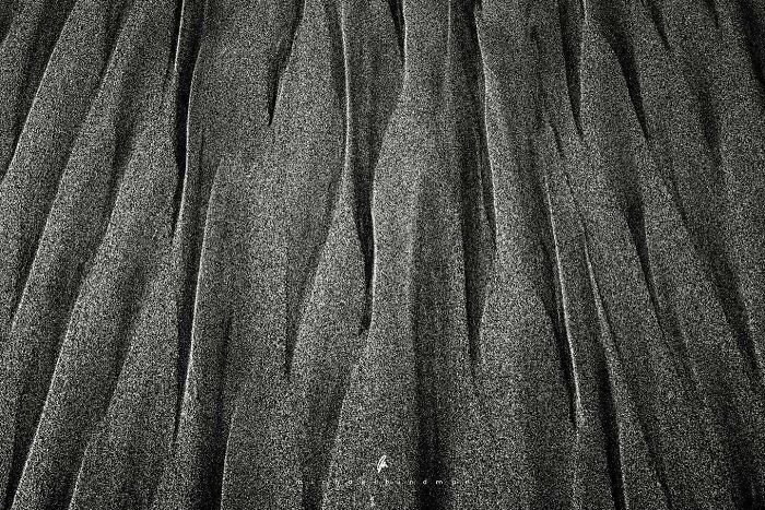 Intimate landscape photo by Michael Hindman showcasing textured sand patterns.