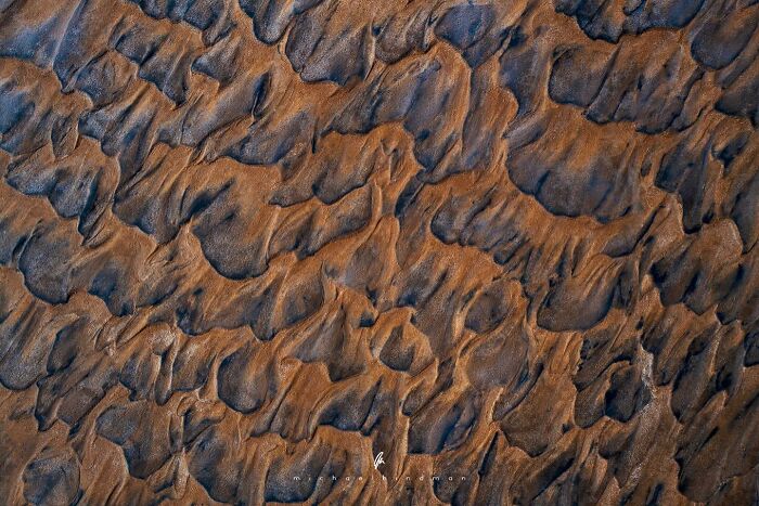 Intricate textures of nature in a close-up landscape photo by Michael Hindman, showcasing earthy patterns.