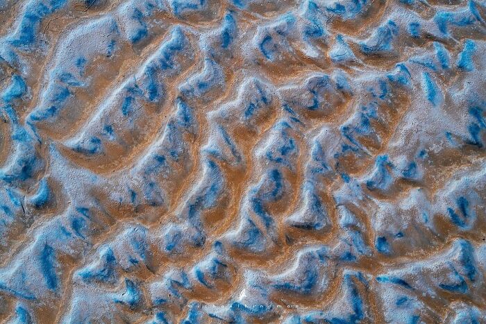 Patterns in nature showing textured landscape of brown and blue tones.