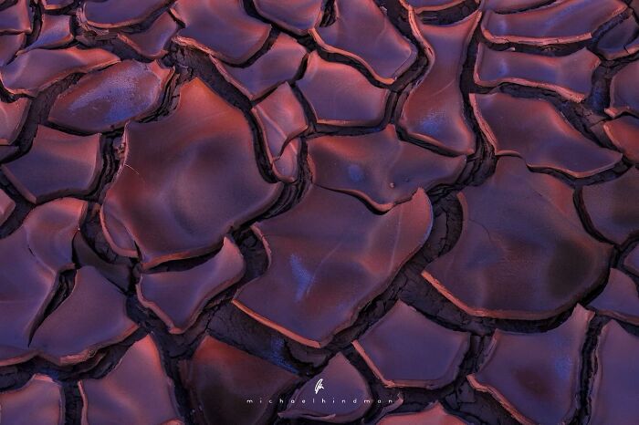 Cracked earth patterns in an intimate landscape photo by Michael Hindman, showcasing the textures of nature.