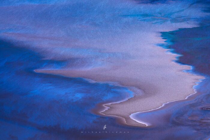 Intimate landscape photo by Michael Hindman featuring abstract textures of blue and earthy tones in nature.