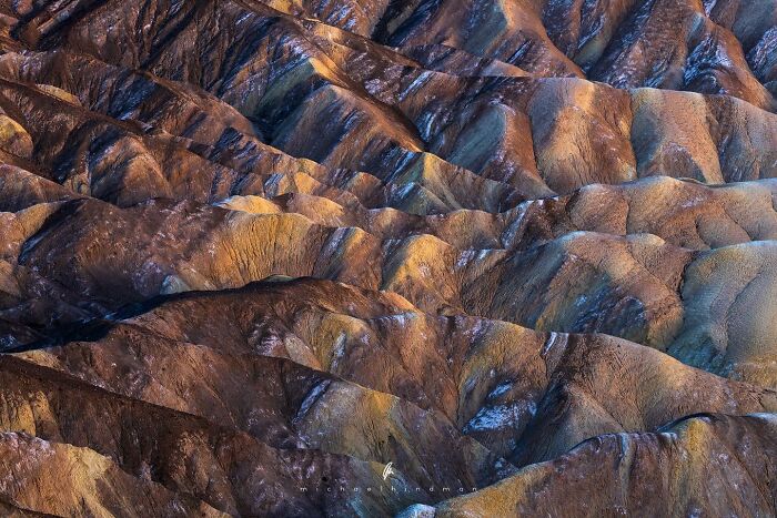 Intimate landscape photo of textured, rugged terrain with earthy tones, showcasing nature's patterns.