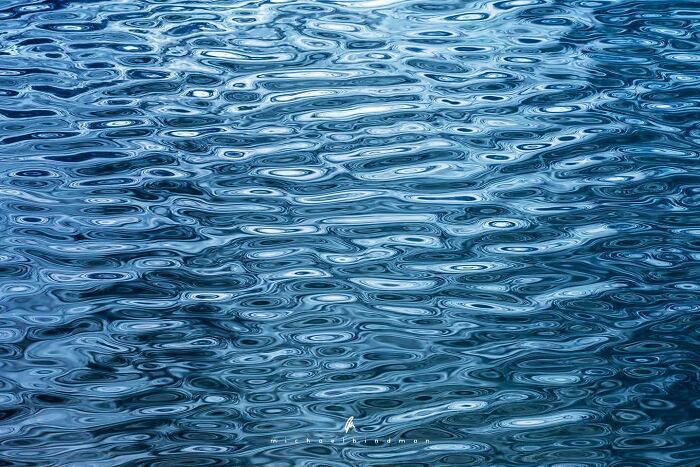 Rippling water surface showcasing nature's textures in an intimate landscape photo by Michael Hindman.