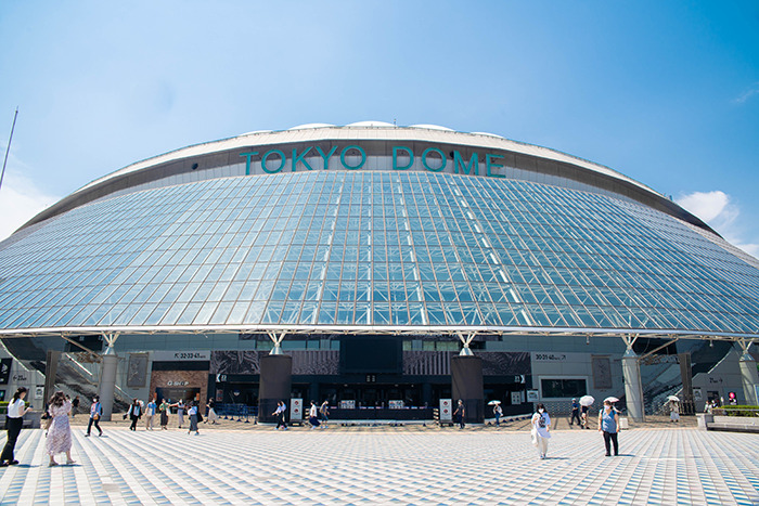 Tokyo Dome exterior on a sunny day, showcasing its modern architecture.