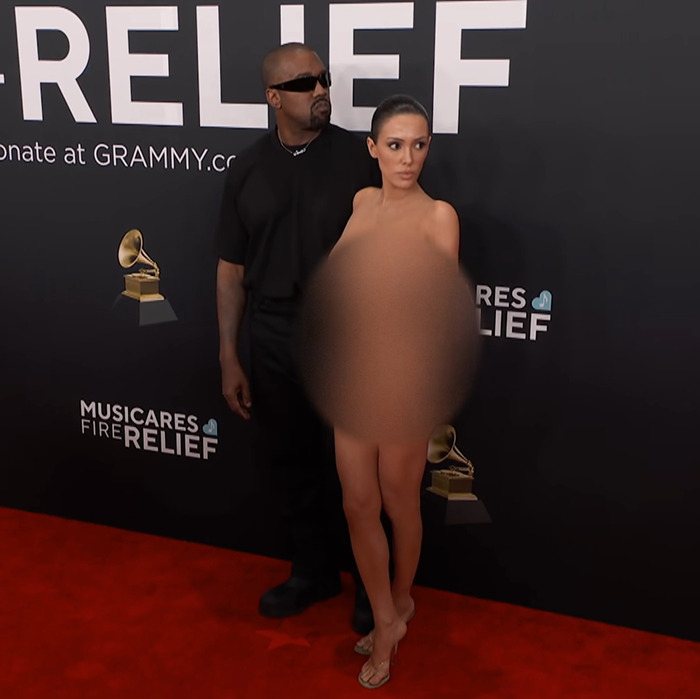 Kanye West and Bianca Censori on the red carpet at a Grammy event.