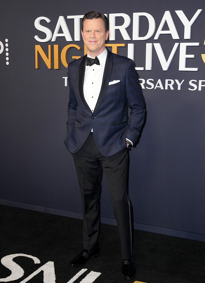 Person in a tuxedo at SNL 50th Anniversary red carpet.