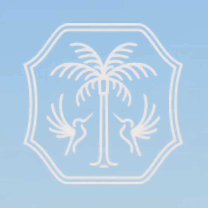 Town logo with palm tree and birds against a blue sky background, related to rebranding controversy.