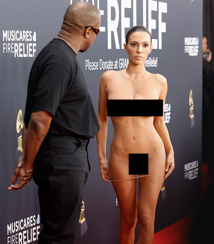 Bianca Censori on the red carpet in a controversial dress at MusiCares event, sparking celebrity criticism.