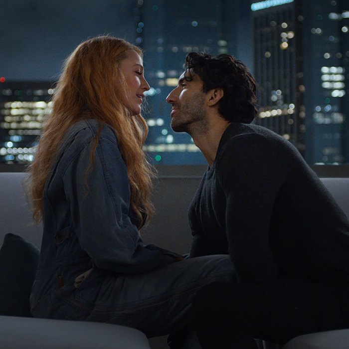 Couple sharing an intimate moment on a city rooftop, highlighting Justin Baldoni's scene dynamics in "It Ends With Us".