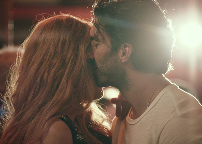 Man and woman in an intimate moment with bright light behind them, related to Justin Baldoni in 