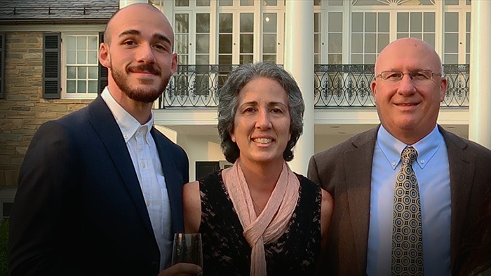 A family posing outside a stately building; related to Brian Laundrie's parents' statement on Gabby Petito documentary.