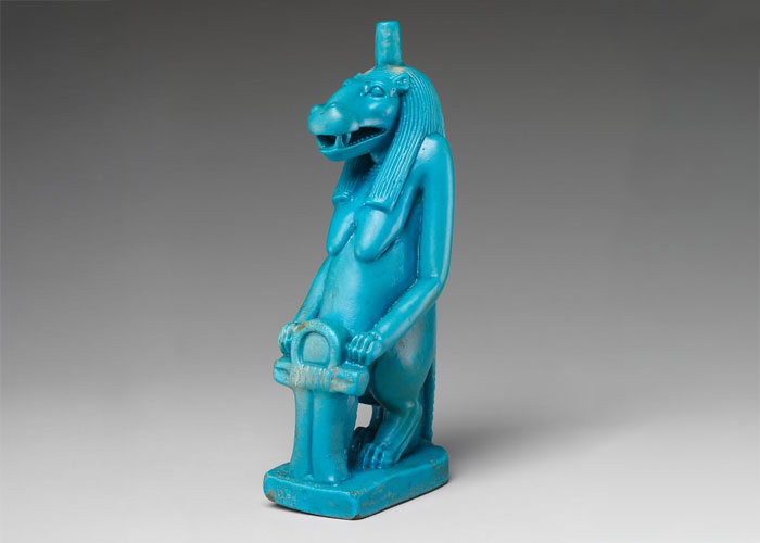 Ancient Egyptian artifact, a blue hippo statue, originally stolen from a museum, depicted in a detailed, isolated view.