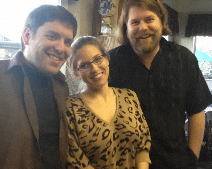 Matthew Van Andel with family smiling indoors.