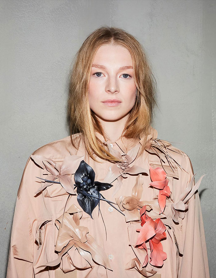 Trans actress in a floral shirt, representing gender identity issues in public documents.