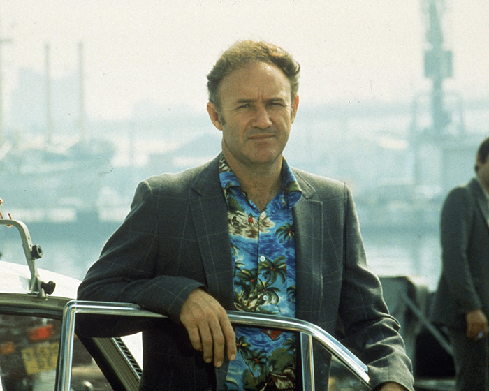 A person in a tropical shirt and blazer near a marina, in relation to Gene Hackman investigators' update.