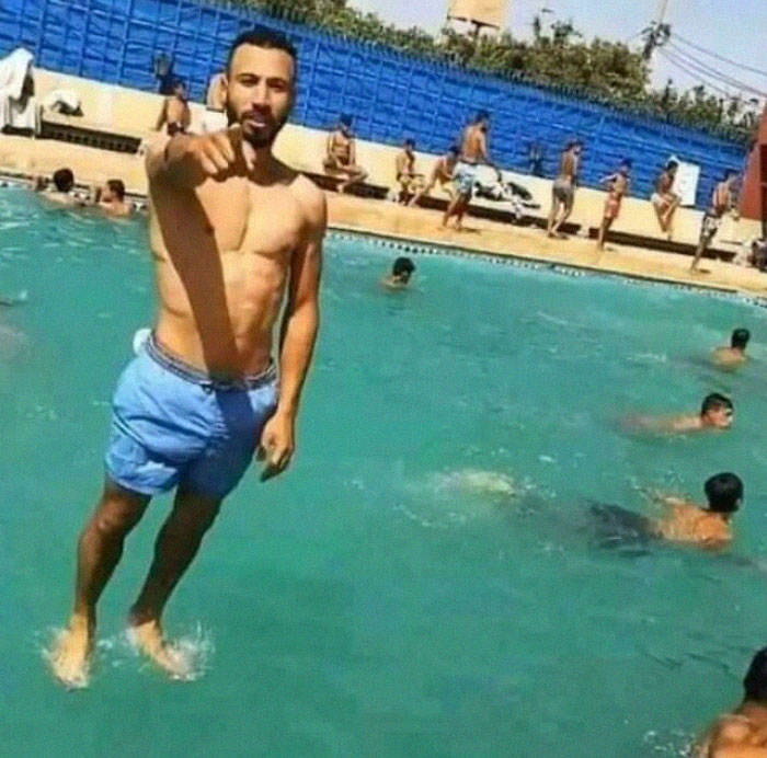 Man standing on water in a pool, pointing towards the camera, resembling a “final boss” moment in real life.