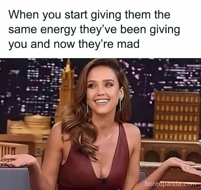 A woman smiling on a talk show, captioned with relatable humor for women about matching others' energy.