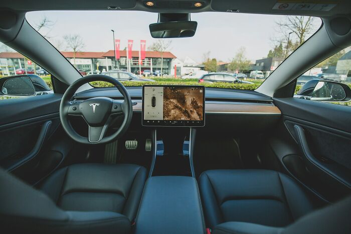 Tesla car interior showcasing modern dashboard and steering wheel features, highlighting Gen Zers' tech preferences.