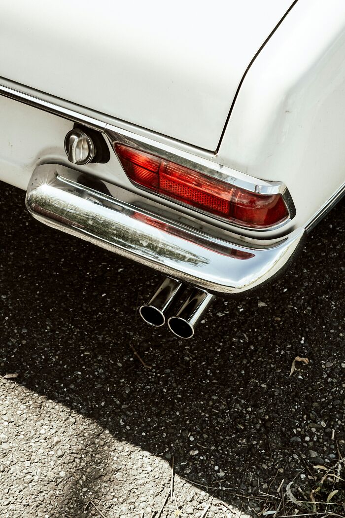 Classic car tail light and exhaust, illustrating a Gen Zer's boomer complaint.