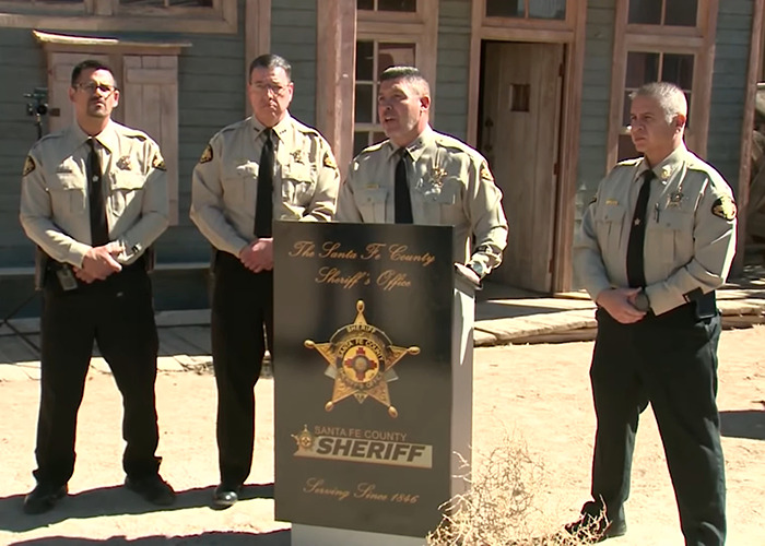 Four sheriffs in uniform stand beside a podium during a sunny outdoor press conference.