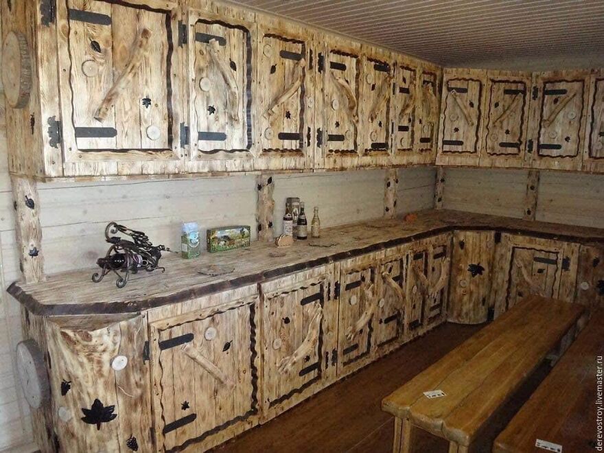 Rustic wooden kitchen with mismatched cabinetry design, showcasing unconventional architecture styles.