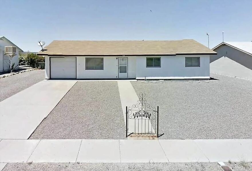 Simple house with minimal landscaping, illustrating architecture shaming potential.