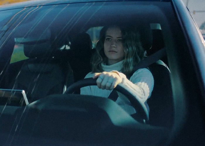 A woman driving a car, related to the momfluencer abuser docuseries.