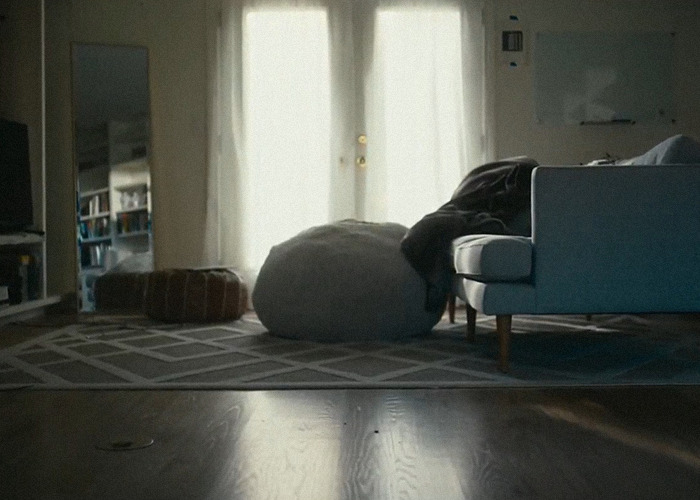 Living room with soft light, featuring a couch, bean bag, and rug, related to the Ruby Franke momfluencer docuseries.