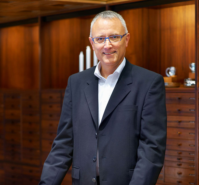 A man in formal attire stands in a wood-paneled room, symbolizing fantasy romance book tropes.