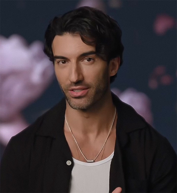 Man in a black shirt and white tank top speaking against a dark, softly blurred background; texts question fat-shaming claims.