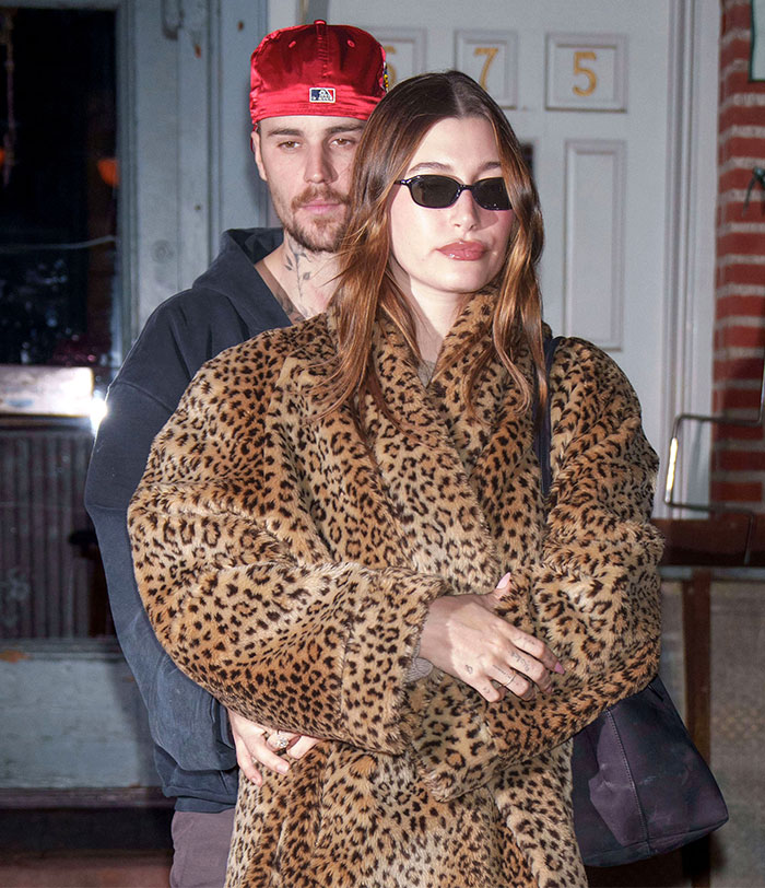 A person in a leopard print coat and sunglasses, standing in front of another wearing a red cap; addressing substance abuse rumors.