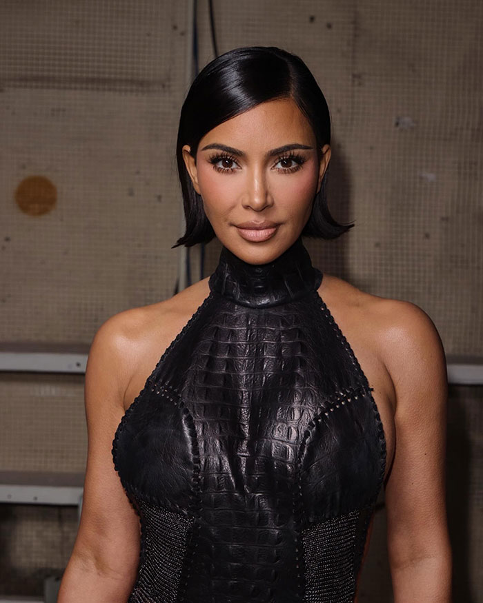 Kim Kardashian in a chic black dress, praised for her classy style.