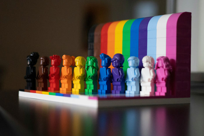 Lego bricks arranged in rainbow colors, symbolizing diversity and inclusivity against anti-LGBT claims.