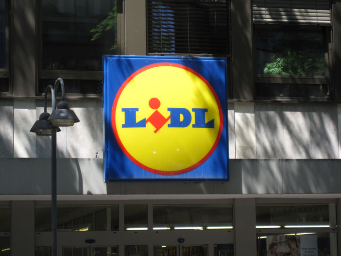 Lidl store sign displayed on a building facade, highlighting the brand's Valentine's Day beauty box offer.