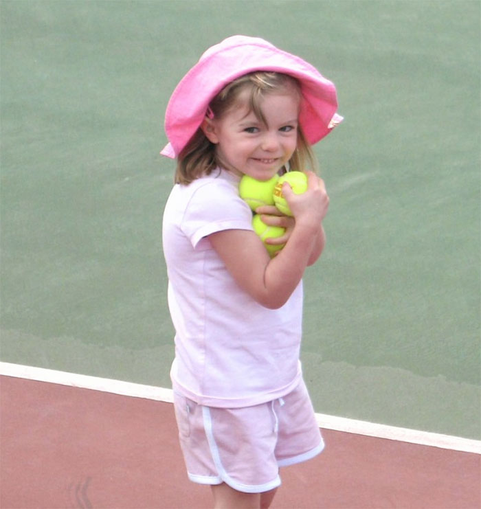 A young girl in pink holding tennis balls on a court, related to the Madeleine McCann case.