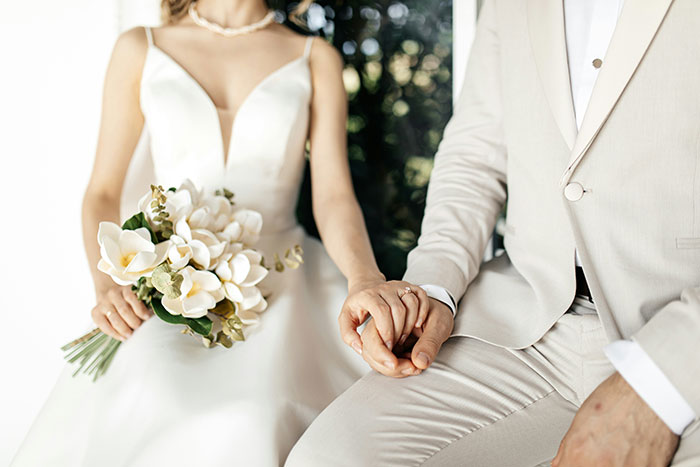 A couple in formal attire holding hands, highlighting an ultimatum situation related to a birthday party.