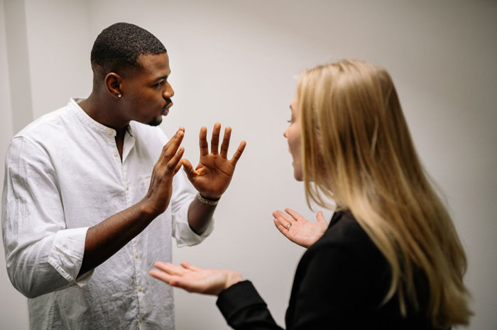 Man and woman in heated discussion, referring to issues of pet sitting and an expensive vet.