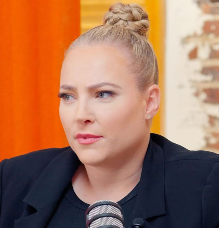 Woman with braided hair in a black outfit, speaking into a microphone about Bianca Censori's Grammys dress.