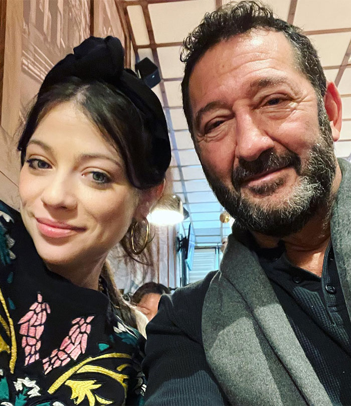 A couple smiling together in a cozy cafe setting, reflecting warmth and companionship.