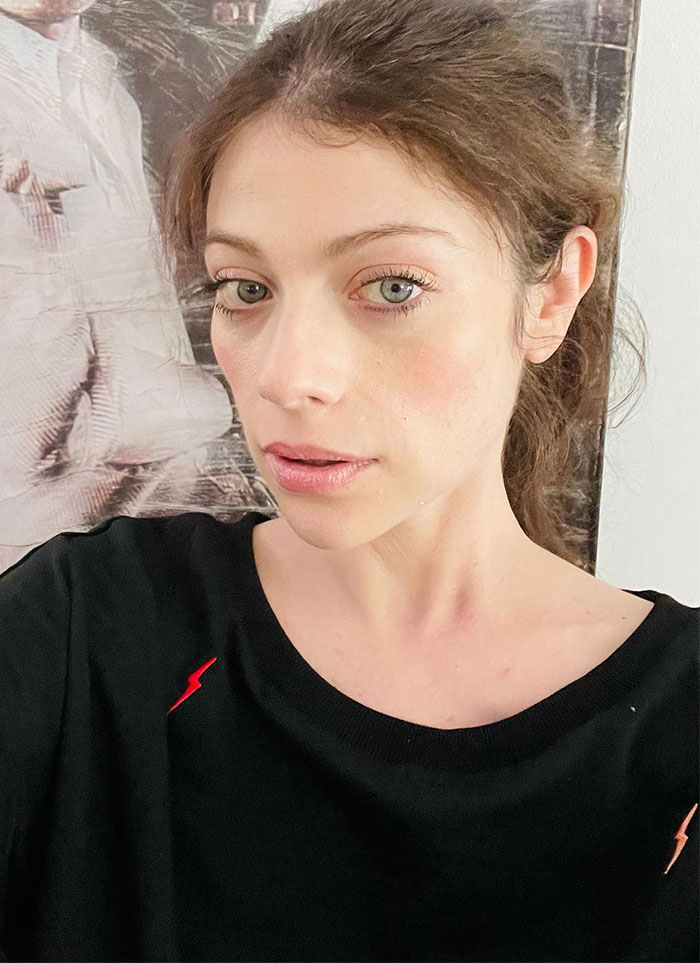 Portrait of a woman with light brown hair in a black shirt, related to Buffy star Michelle Trachtenberg.