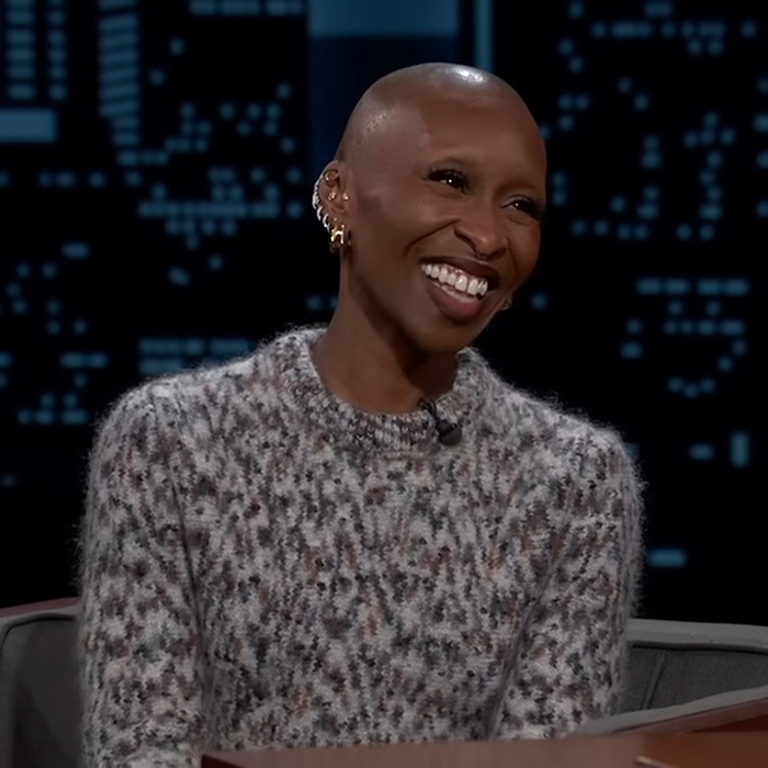 Actor smiling during an interview, wearing a patterned sweater, amidst discussions on casting in the new musical.