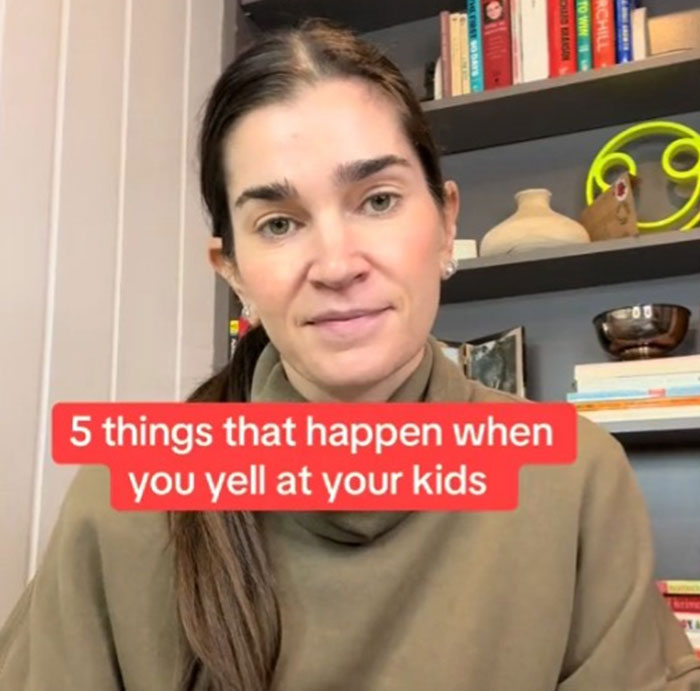 Parenting coach discussing effects of yelling at kids in an informal setting with bookshelves in the background.