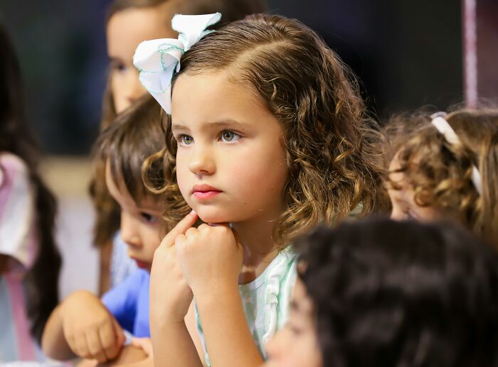 Group of young children with one girl in focus, reflecting on thoughts about childfree life.