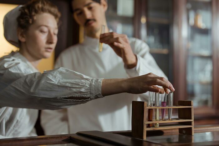 Scientists in lab coats examining test tubes, illustrating future predictions aged bad.