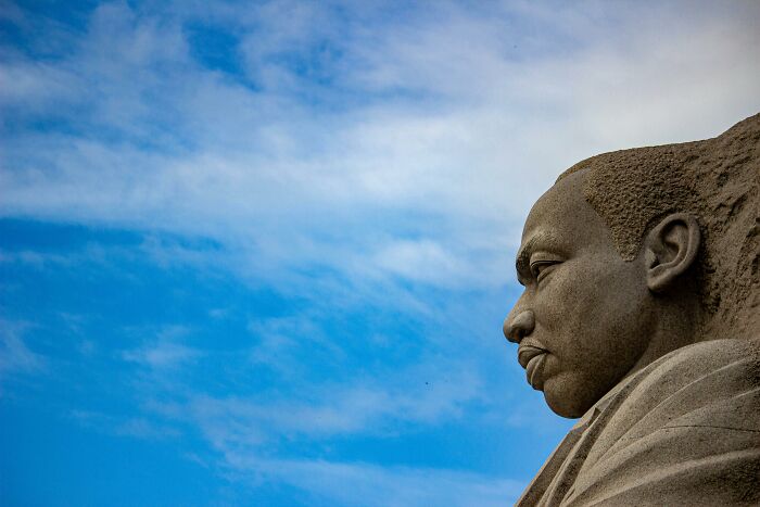 Stone sculpture against a blue sky, representing a powerful mic-drop-moment in history.